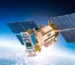 A satellite is flying in the sky above the earth.